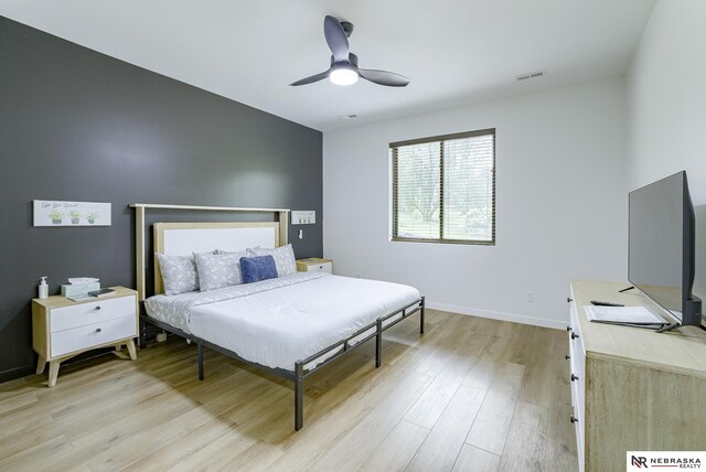 bedroom with ceiling fan and light hardwood / wood-style flooring