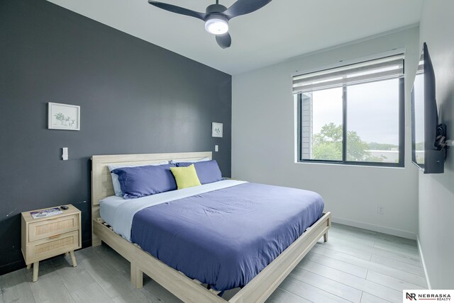 bedroom featuring light hardwood / wood-style flooring and ceiling fan