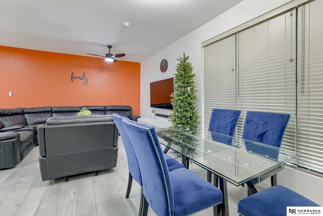 dining space with light wood-type flooring and ceiling fan