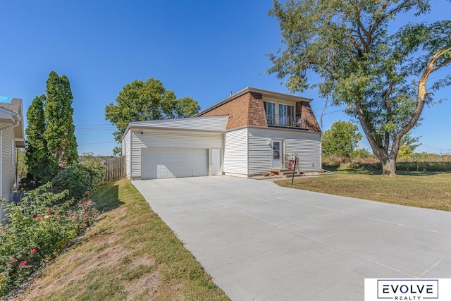 view of front of house featuring a garage and a front lawn