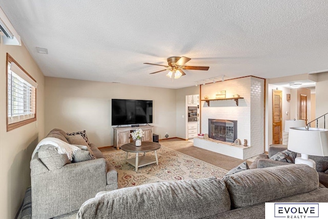 living room with a textured ceiling, light carpet, and ceiling fan