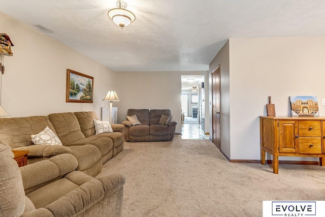 living room with light carpet and a textured ceiling