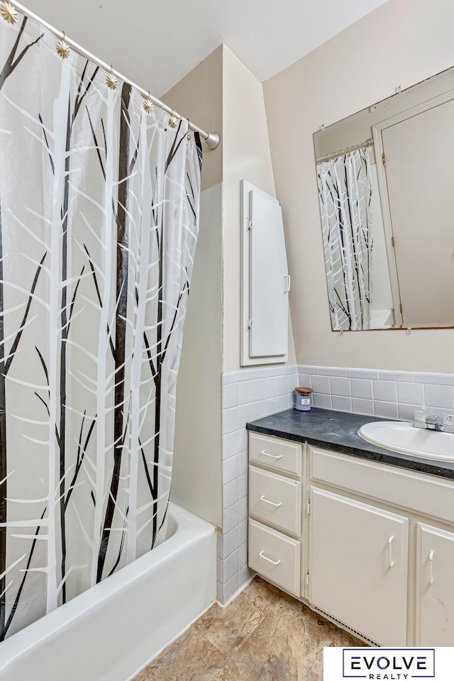 bathroom featuring shower / bath combo and vanity