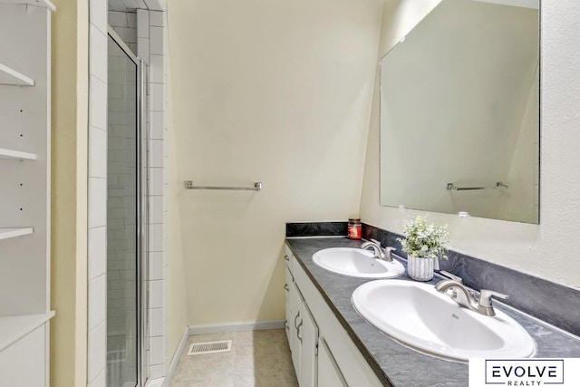 bathroom with vanity, a shower with door, and tile patterned floors