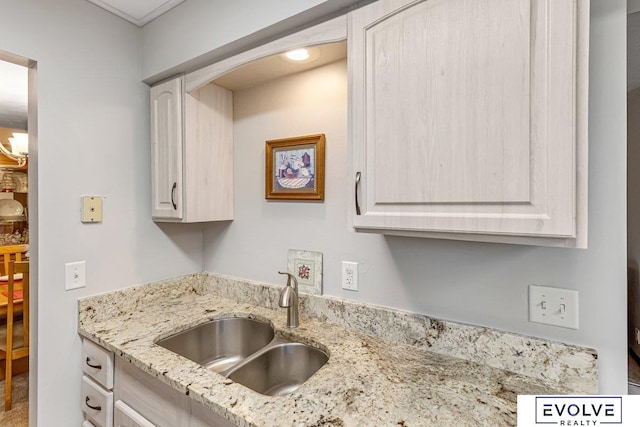 kitchen with light stone countertops and sink