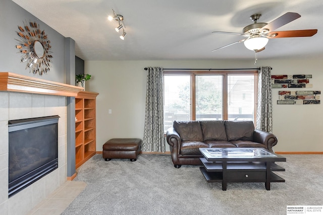 carpeted living room featuring ceiling fan and a fireplace