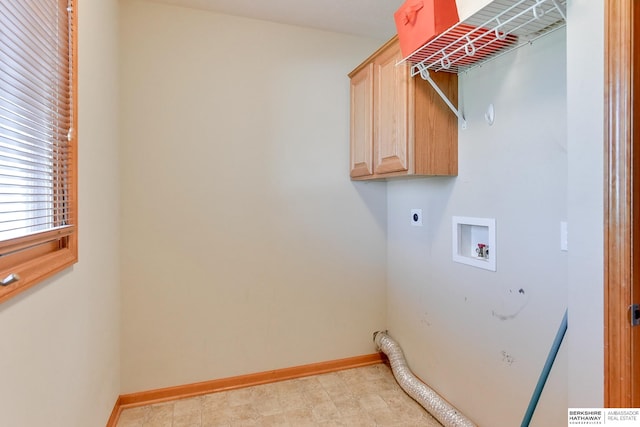 washroom with hookup for a washing machine, electric dryer hookup, and cabinets