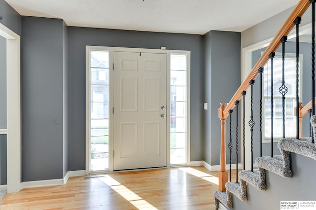 foyer featuring light hardwood / wood-style flooring and a healthy amount of sunlight