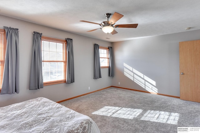 unfurnished bedroom with a textured ceiling, light carpet, and ceiling fan