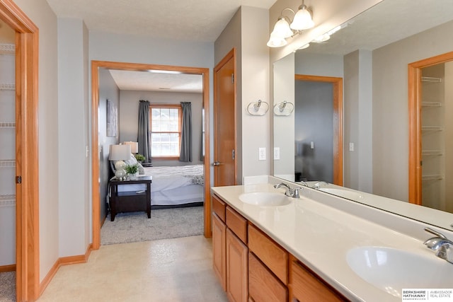 bathroom featuring a textured ceiling and vanity