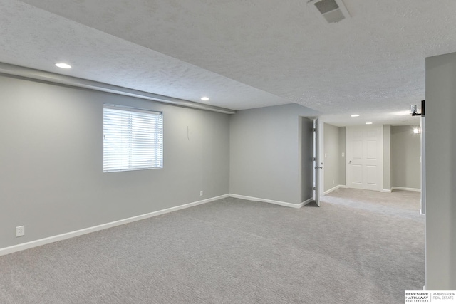 interior space with light colored carpet and a textured ceiling