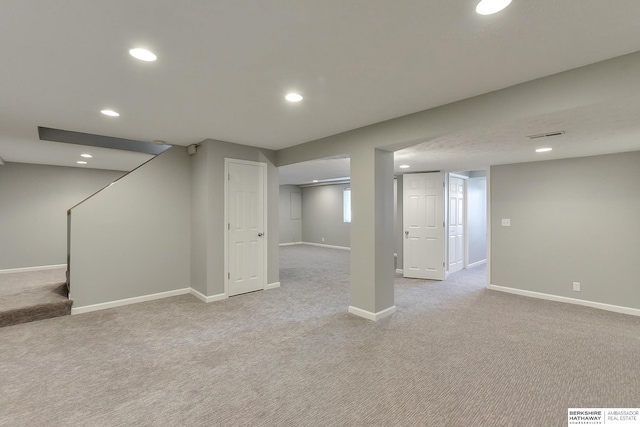 basement featuring light carpet