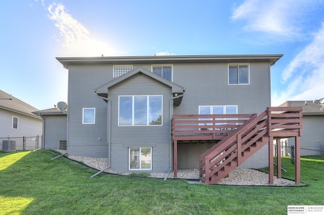 back of house featuring a yard, central air condition unit, and a wooden deck