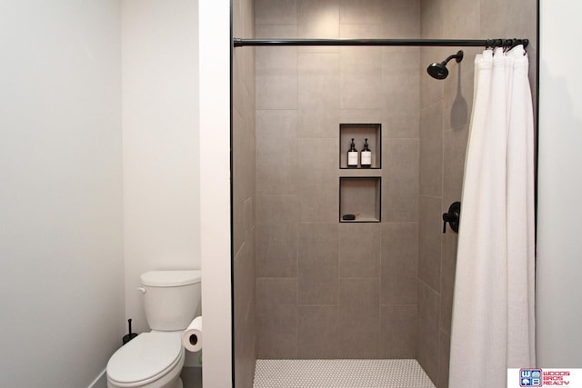 bathroom featuring walk in shower and toilet