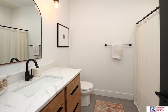 bathroom featuring tile patterned floors, vanity, and toilet