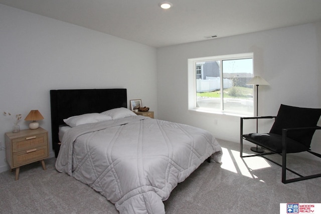 bedroom featuring light carpet