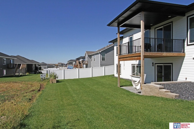 view of yard with a balcony