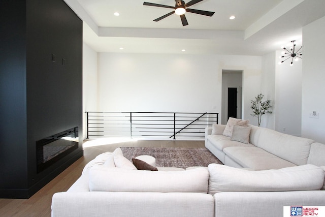 living room featuring wood-type flooring and ceiling fan