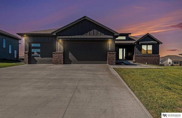 view of front of home featuring a garage and a lawn