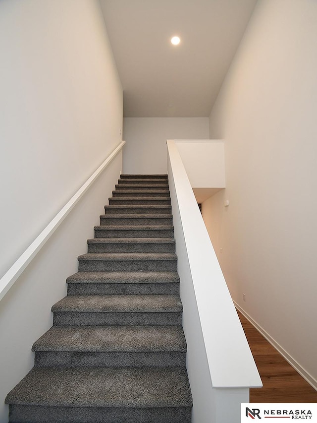 staircase with hardwood / wood-style flooring