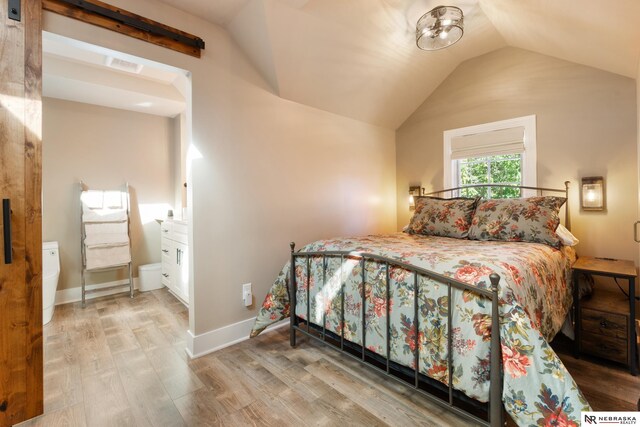 bedroom featuring vaulted ceiling and hardwood / wood-style flooring