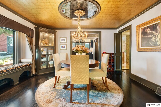 dining area featuring crown molding, dark wood-type flooring, and a chandelier