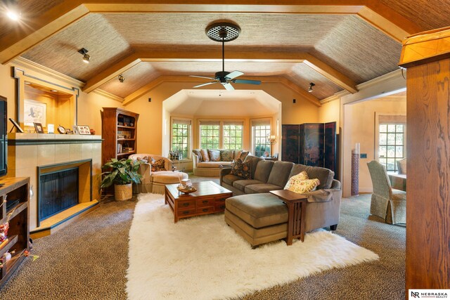 living room with carpet, a fireplace, vaulted ceiling, and ceiling fan