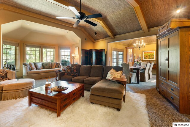 carpeted living room featuring ceiling fan with notable chandelier and lofted ceiling