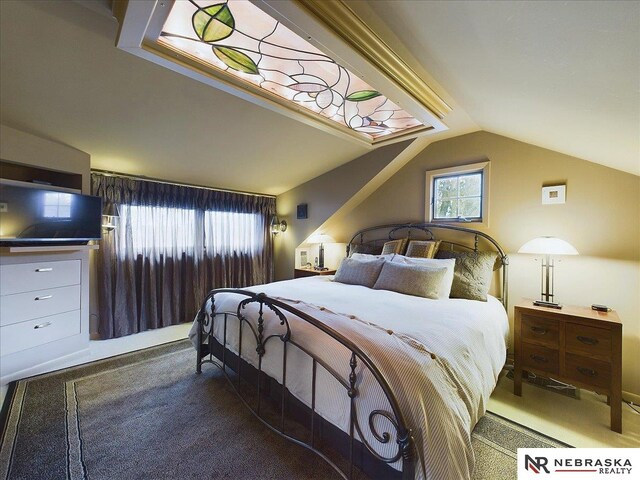 carpeted bedroom with vaulted ceiling