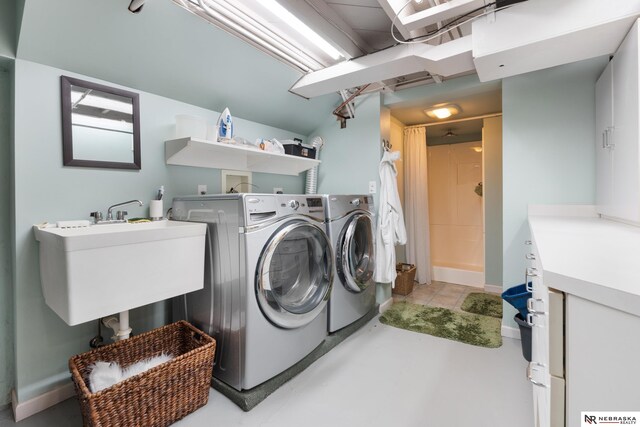 washroom featuring washer and clothes dryer and sink