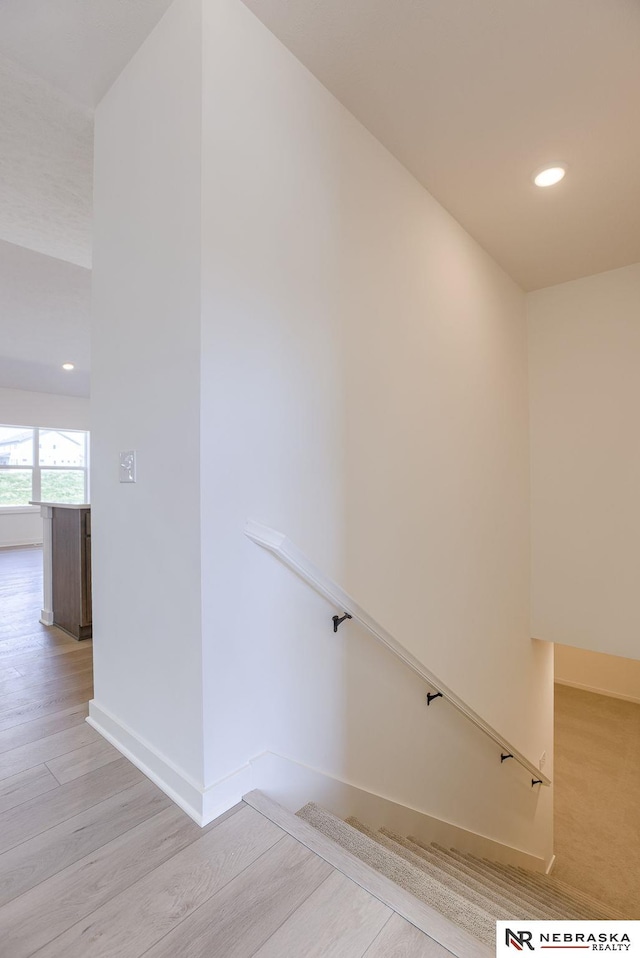 staircase featuring wood-type flooring