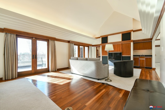 living room with light wood-type flooring, high vaulted ceiling, french doors, and plenty of natural light