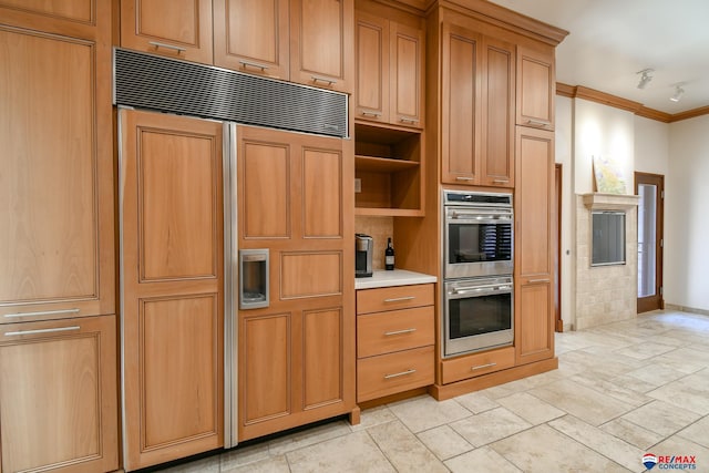 kitchen featuring paneled refrigerator, crown molding, and double oven