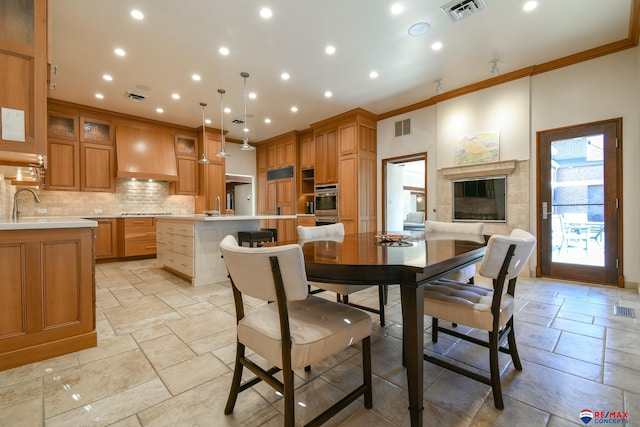 dining area featuring ornamental molding and sink