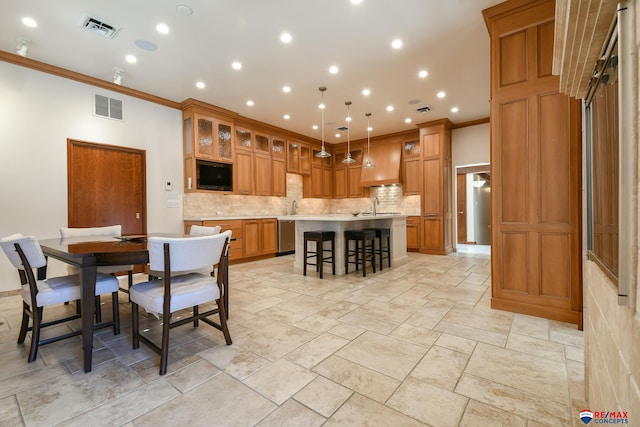 dining space featuring ornamental molding and sink