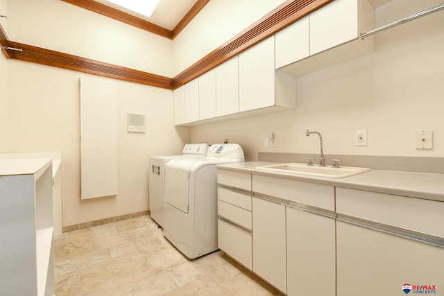 washroom featuring sink, independent washer and dryer, and cabinets