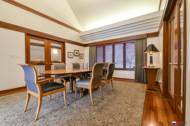 dining area with french doors, lofted ceiling, and dark wood-type flooring