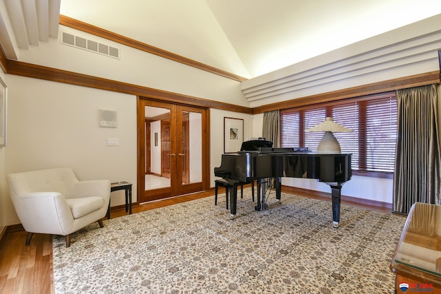 miscellaneous room with vaulted ceiling, hardwood / wood-style floors, and french doors