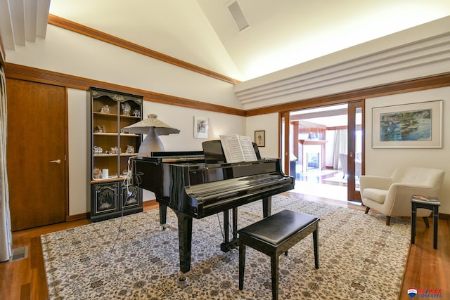 misc room with hardwood / wood-style floors and vaulted ceiling