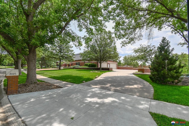 view of front of property featuring a front yard and a garage