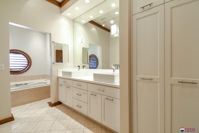 bathroom featuring tile patterned flooring, tiled tub, vanity, and crown molding