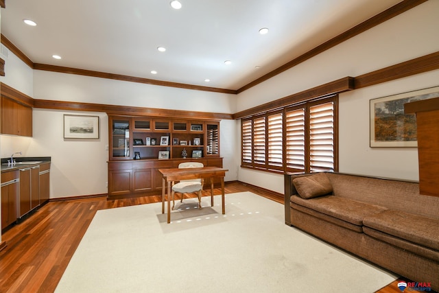 office space featuring sink, crown molding, and dark wood-type flooring