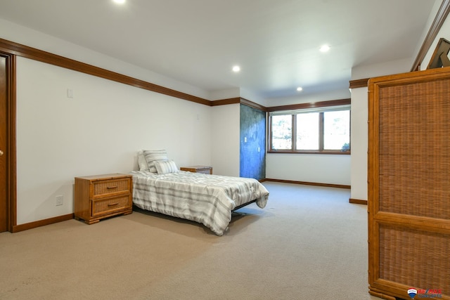 bedroom featuring ornamental molding and light colored carpet