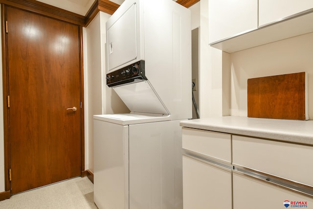 washroom featuring stacked washer / dryer