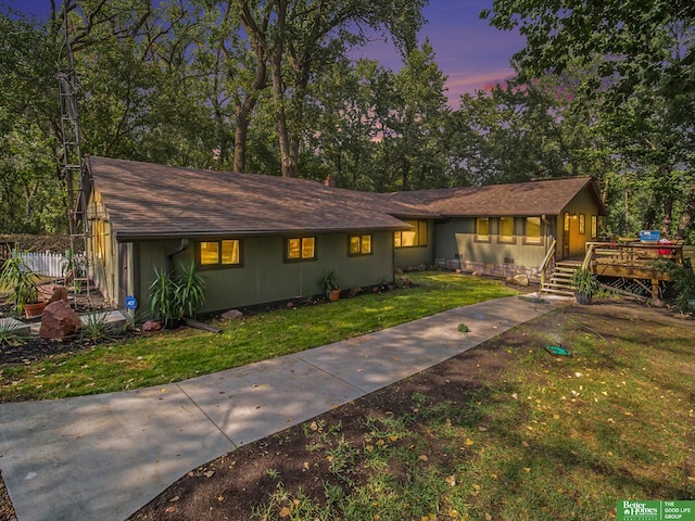 ranch-style home with a yard