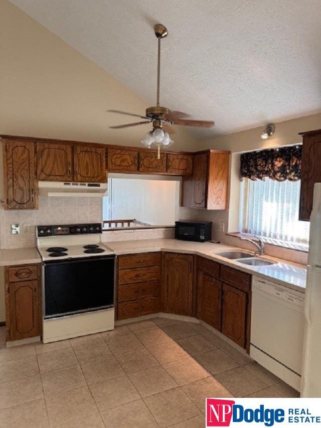 kitchen with ceiling fan, sink, white appliances, tasteful backsplash, and a textured ceiling