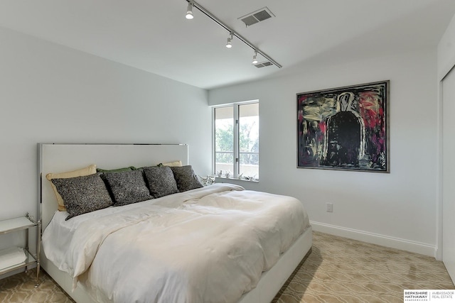 bedroom featuring track lighting