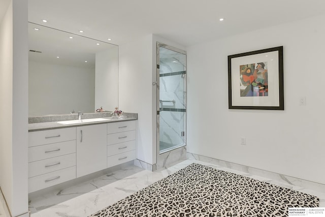 bathroom with walk in shower and vanity