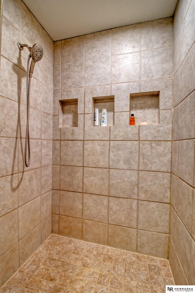 bathroom with tiled shower