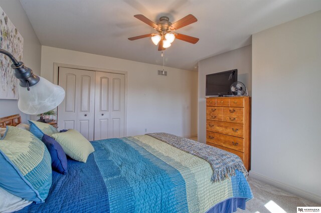 bedroom with a closet, carpet floors, and ceiling fan